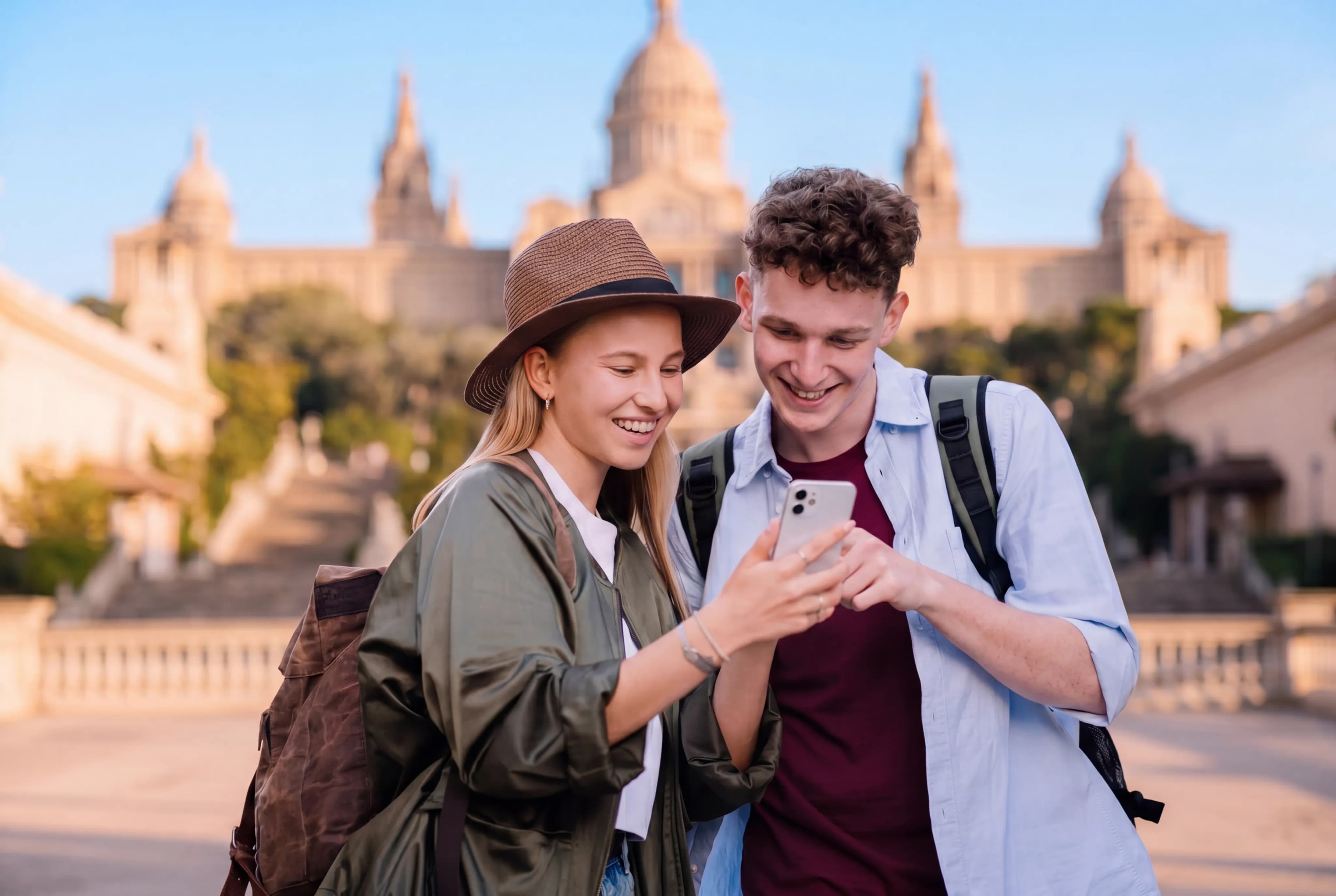Travelers using a guide on their phone in front of a landmark